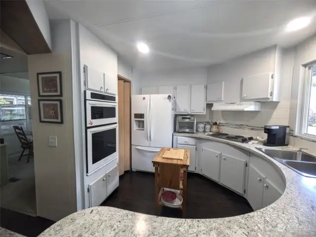 Large kitchen with new dishwasher and newer built-in microwave/oven & fridge. Pantry next to fridge and lots of counterspace