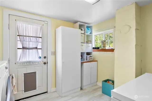 Laundry room w/backdoor access to the yard and detached garage