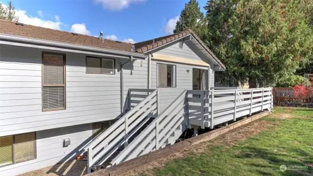 A view of the home featuring the deck and stairs, providing easy access to the outdoors.