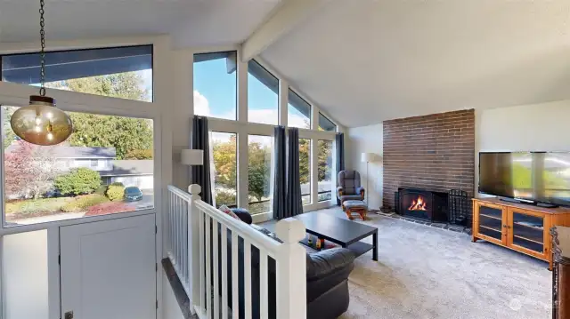 A view of the living room, featuring a staircase leading into the spacious and inviting space.