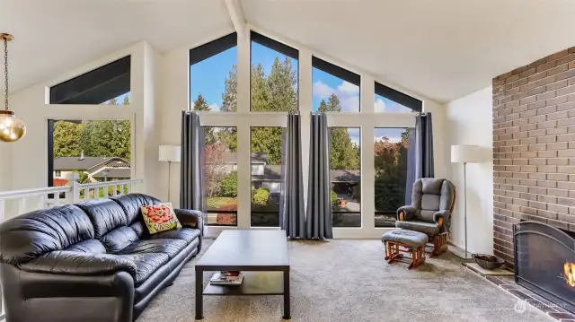 A stunning wall of windows in the living room floods this space with natural light.