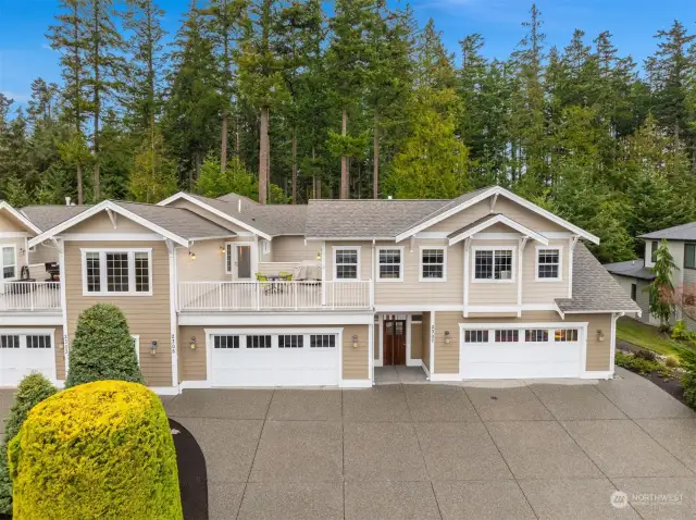 Welcome to this re-designed condo for those looking to live in luxury. The front door is to left, hidden behind tree in this photo.