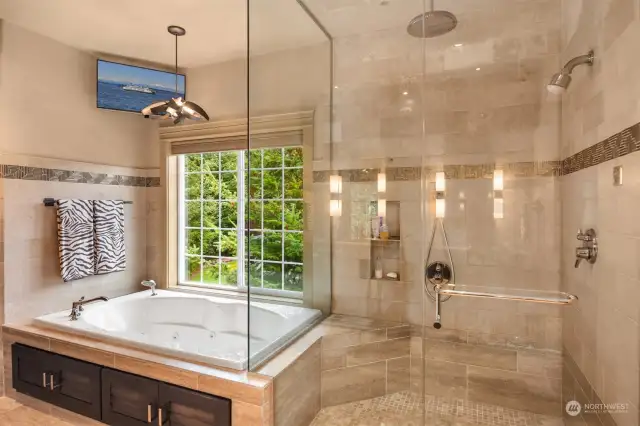 Relax in the Kohler jetted tub surrounded by Huberton Forge Chandelier, sconces and towel bars.  Amazing Steam Shower features glass handmade tiles offering a special touch of elegance.