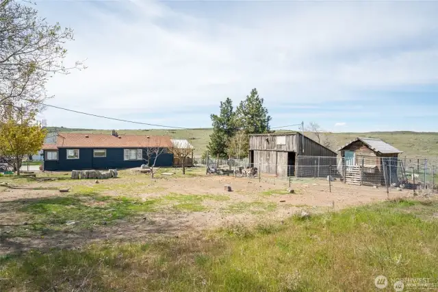 Home, barn, & chicken coop with vast views behind.
