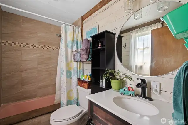 Full bathroom with upgraded tiled surround, new toilet and new sink & vanity.