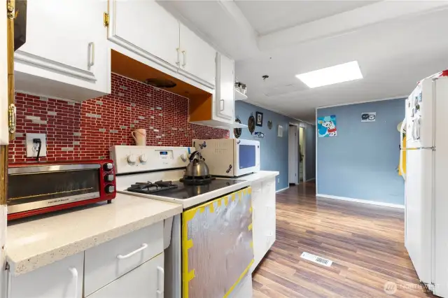 A large skylight brings natural light into the entrance way nearest the carport