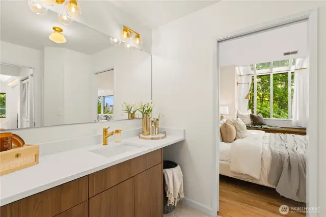 Right off the bedroom is a area with a sink and vanity plus access to the walk-in closet