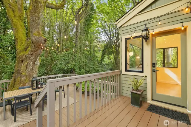 Coming back upstairs the door is off the kitchen and flows out to the back deck sanctuary.