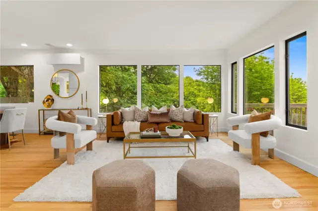 The living room has plenty of windows for natural light. Seasonal view of the city from these windows on the main floor