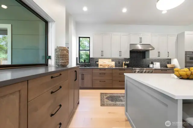 Kitchen has quality finishes. Notice the very cool pass through window to the left.