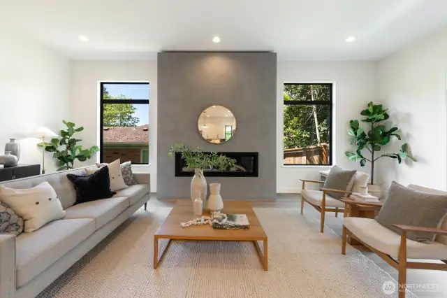 Living space is anchored by a dramatic fireplace flanked by windows; great natural light, perfect for every season.