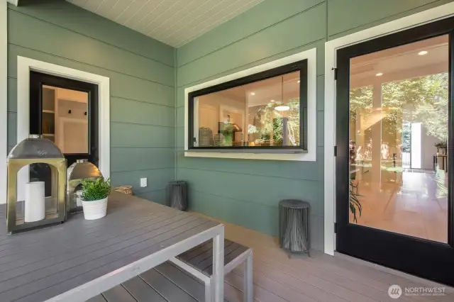 Covered deck with the coolest kitchen passthrough. This space flows directly into the backyard.