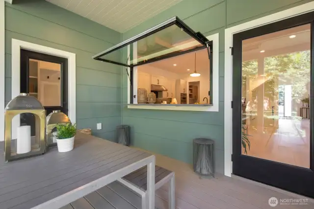Covered deck with the coolest kitchen passthrough. This space flows directing into the backyard.