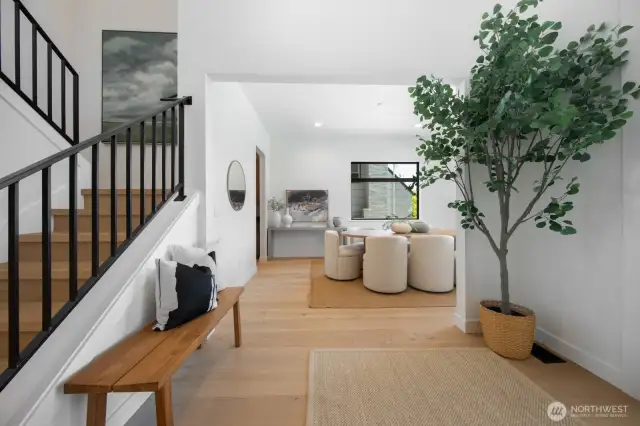 We love this feature staircase; imagine the group photos! Formal dining room is framed from the entry. Welcome.