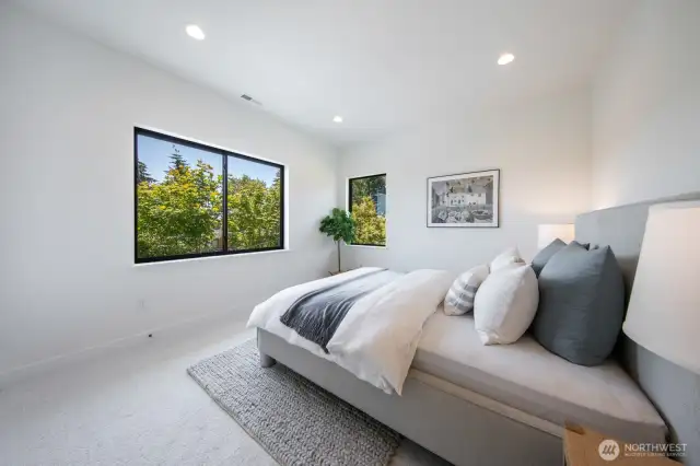 2/4 bedrooms on the top floor; check out all of the greenery out the window.