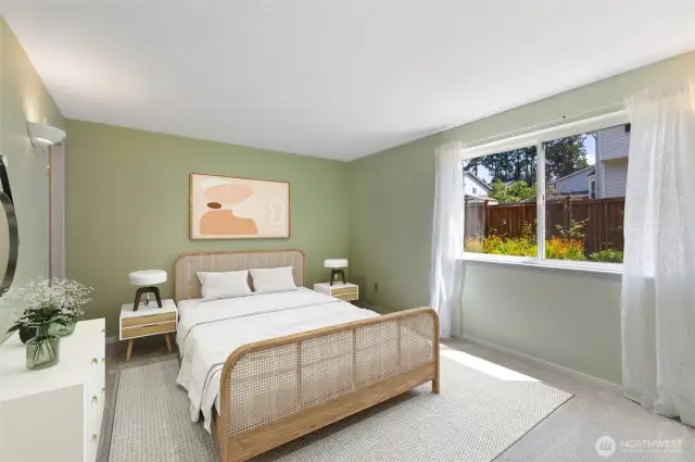 Spacious primary suite with new carpet, soothing tones, and a private en suite bath—designed for comfort, relaxation, and waking up to the morning sun (Virtually staged)