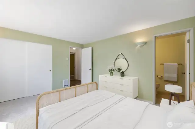 A second look at the primary suite, highlighting its fresh finishes, easy flow to the en suite bath, and calming atmosphere throughout. (Virtually Staged).