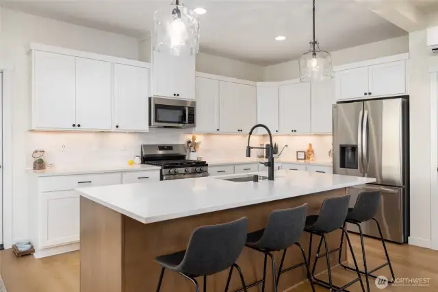 The microwave/hood is built-in and quartz countertops.