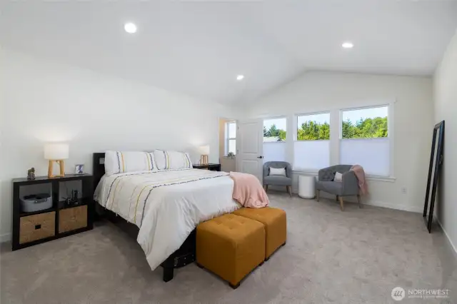 The primary suite has vaulted ceilings & room for lots of furniture.