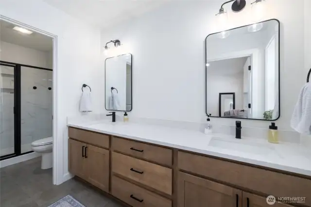 Primary ensuite has double sinks and a separate room for the tile shower.
