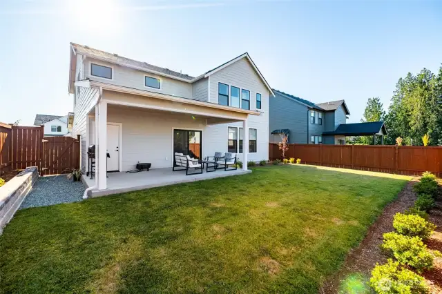 The backyard is landscaped and fenced.