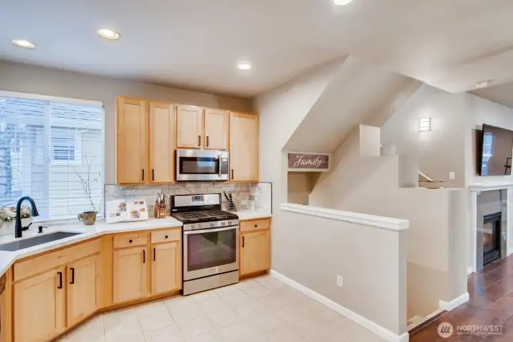 Kitchen view toward the living space and stairs, creating an open and connected feel.