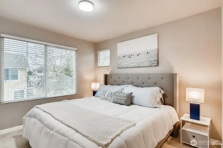Third-floor bedroom with ample space for a king bed and provides a bright, open feel.