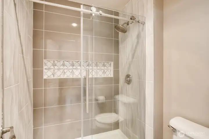 Ensuite bath with a modern, glass-enclosed shower.