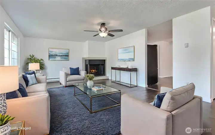 Living room is spacious, airy and room for gatherings. Virtually staged.