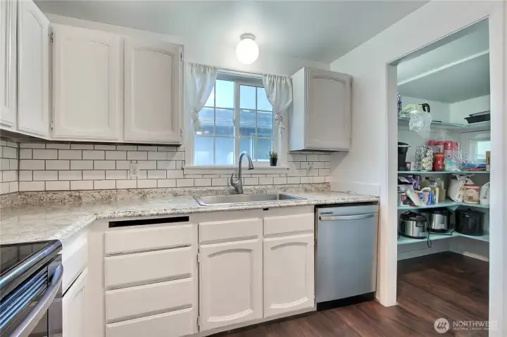 View of the kitchen with nice sized pantry.