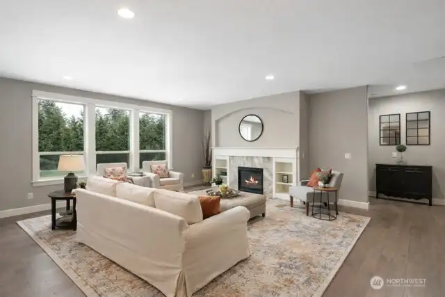 Cozy fireplace and open to gourmet kitchen, eating area and kitchen island with pendant lighting and granite countertops