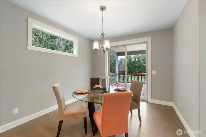 Eating nook in kitchen leads to covered outdoor deck