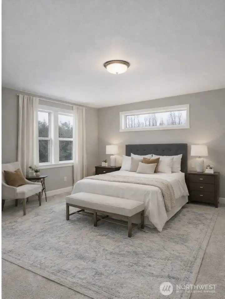 Main floor primary ensuite features attached 5 piece bath, large walk in closet and backyard views