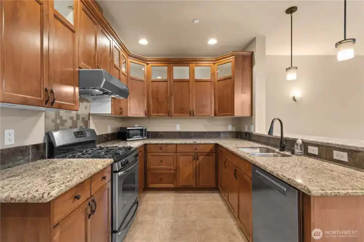 The granite slab countertops that gleam are flanked by natural slate tiles, offering abundant prep space or a spot for all of your favorite gadgets.