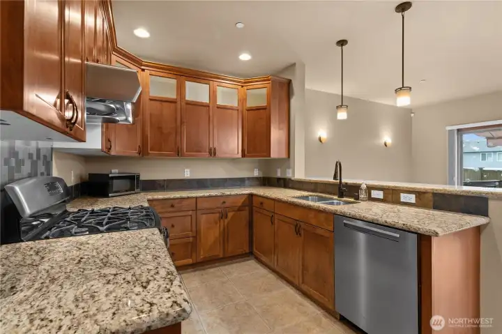 The kitchen peninsula/breakfast bar is open to the great room for ease in entertaining or comfortable chatting while cooking.