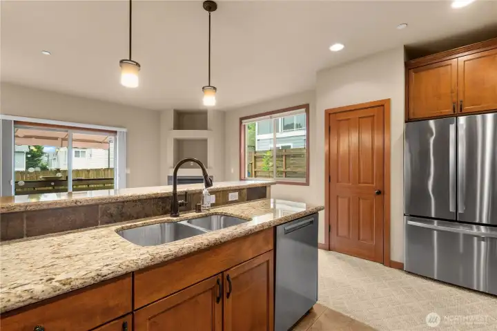Stand at the deep double basin stainless steel sink and look out from the kitchen, feel the kitchen's ceramic tile floors under your feet.
