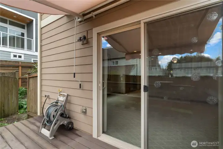 The glass slider opens to the Trex deck, with retractable sunshade above. The circles on the glass are rainbow catchers for sunny days!