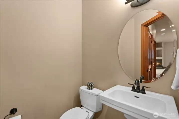 Main floor half bath with eco-friendly Toto toilet, pedestal sink and oiled bronze hardware.