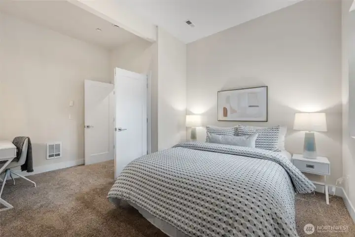 A large additional bedroom downstairs with French doors and tall ceilings is ideal for guests or a home office