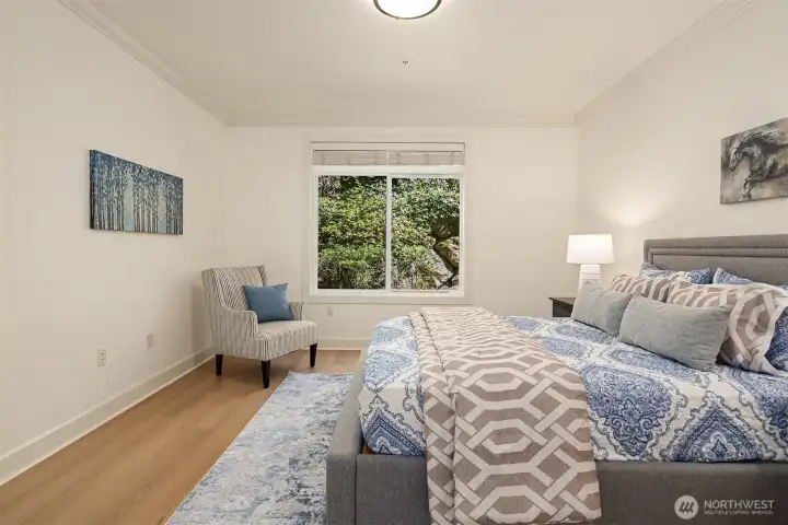 Large window invites abundant natural light and view of lush greenery