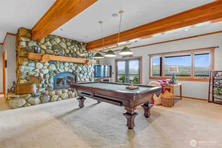 River rock fireplace in the lower level.