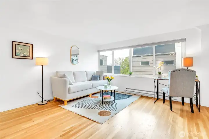 Desirable floor plan with beautiful updates! Spacious living room features a large West-facing window and gleaming refinished hardwood floors.