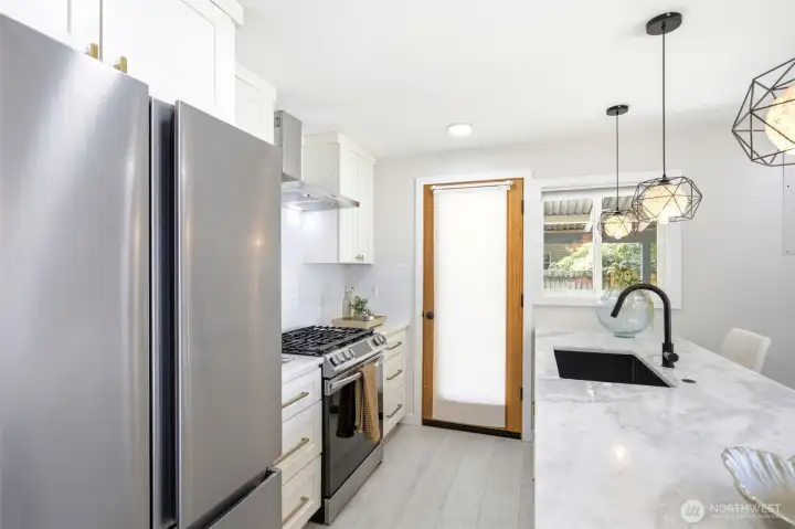 Kitchen back door accesses the backyard