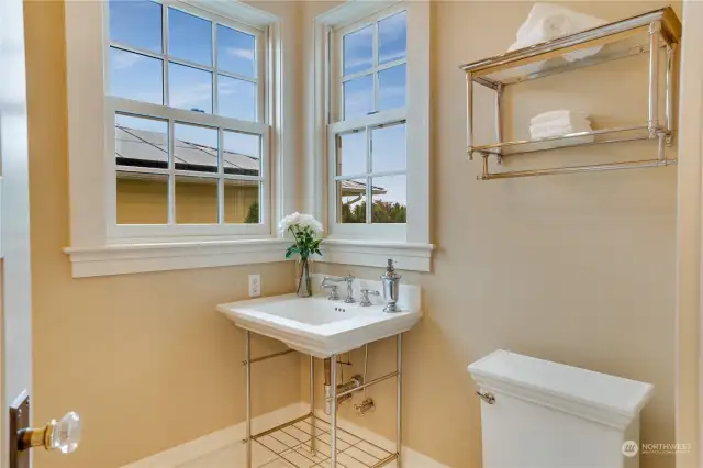 Main floor 1/2 bath is located discretly off the kitchen and also features a view!