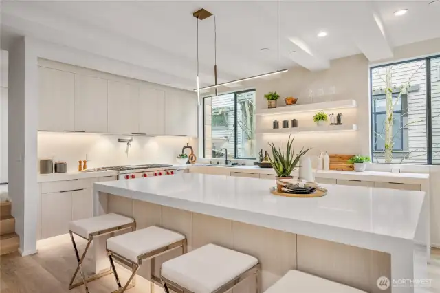 The spacious island, accommodating four stools and additional storage below, is perfect for both dining and organization.