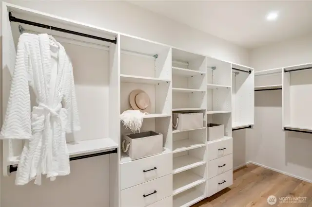 Organized Luxury: The primary closet boasts large custom-built organizers, ensuring ample space and effortless organization.