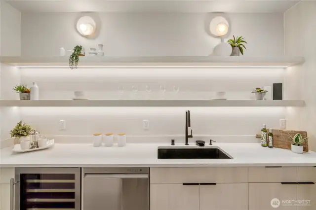 Convenient Entertaining: The lower level kitchenette features a beverage fridge, sink, and dishwasher, perfect for effortless entertaining.