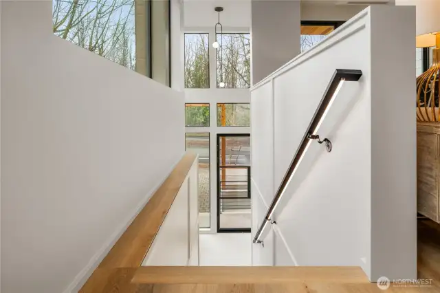 Subtle lighting under the handrail enhances your entry to the main living area.