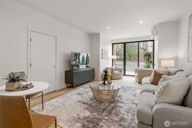 The spacious lower-level family room opens directly to the street-level patio, offering easy access and enhanced indoor-outdoor living.