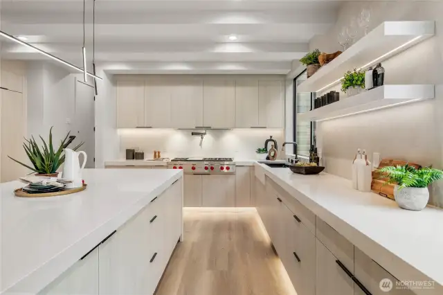 Gourmet Kitchen: Cook and entertain in style with a gourmet kitchen featuring a stunning waterfall quartz countertop and built-in refrigerator.
